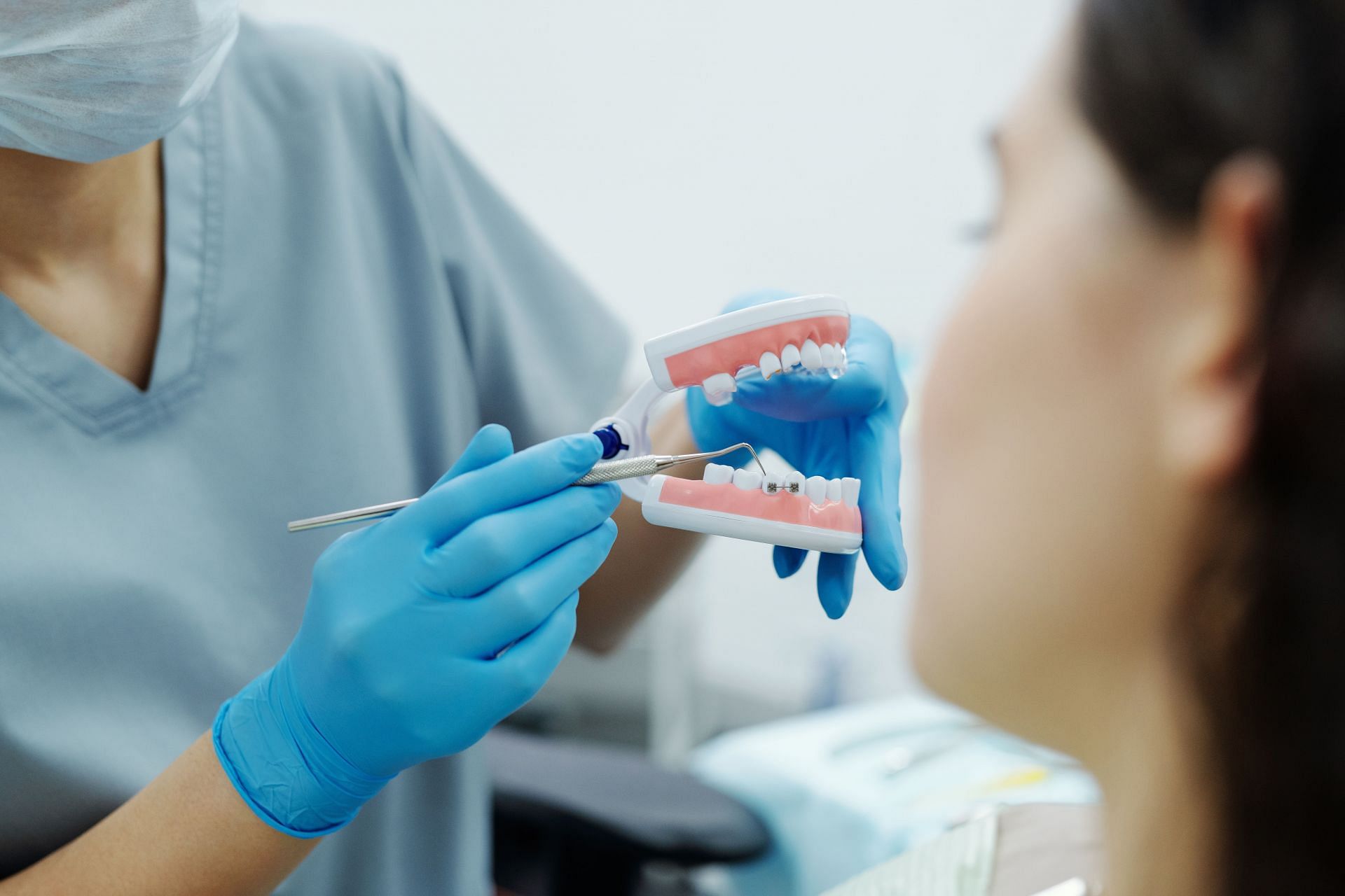 If food gets stuck between the space in your teeth, it might not be cleaned properly only by brushing. That is where flossing comes in (Image via Pexels @Cedric Fauntleroy)